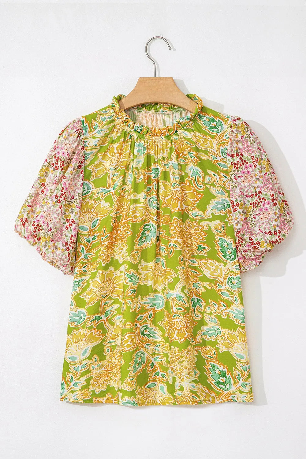 Detail of bubble sleeve and print on multicolour patchwork blouse.