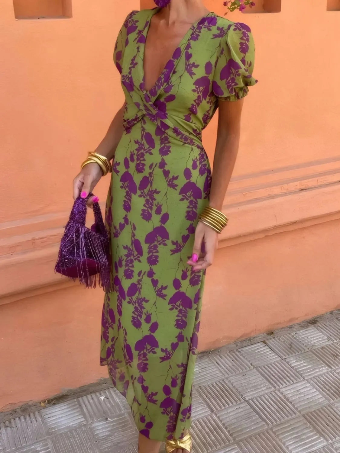 Detail of plunge neckline on printed short sleeve midi dress.