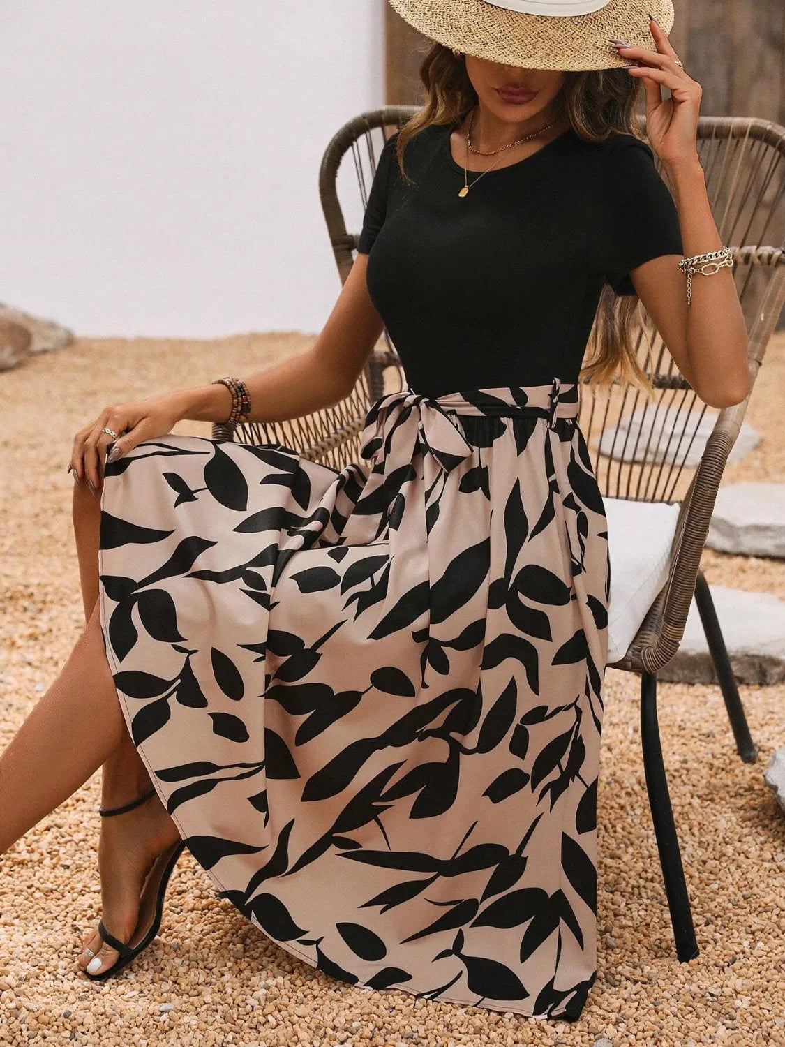 Detail of round neckline on printed short sleeve midi dress.