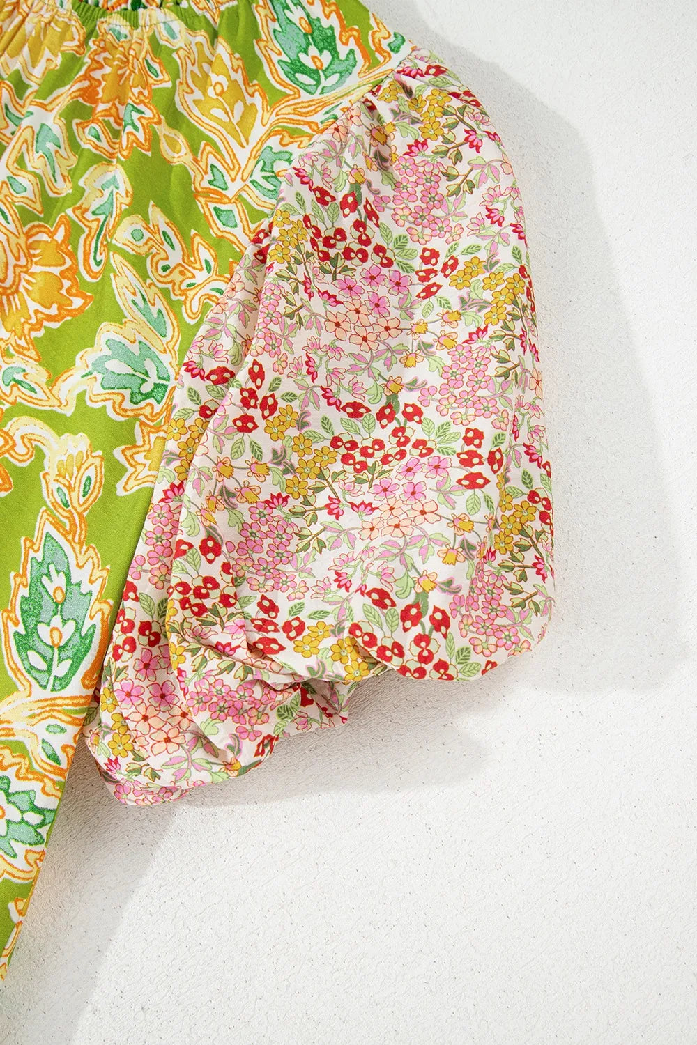 Elegant multicolour patchwork blouse with contrast bubble sleeves.