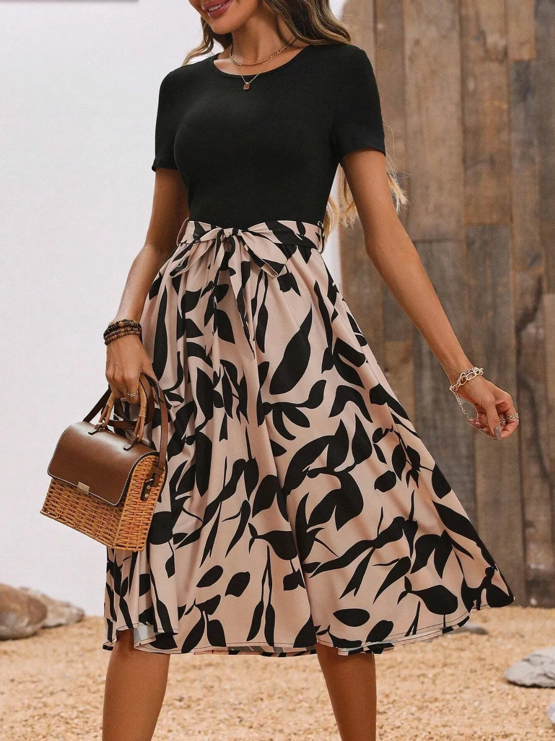 Elegant women's printed midi dress with round neck and short sleeves.