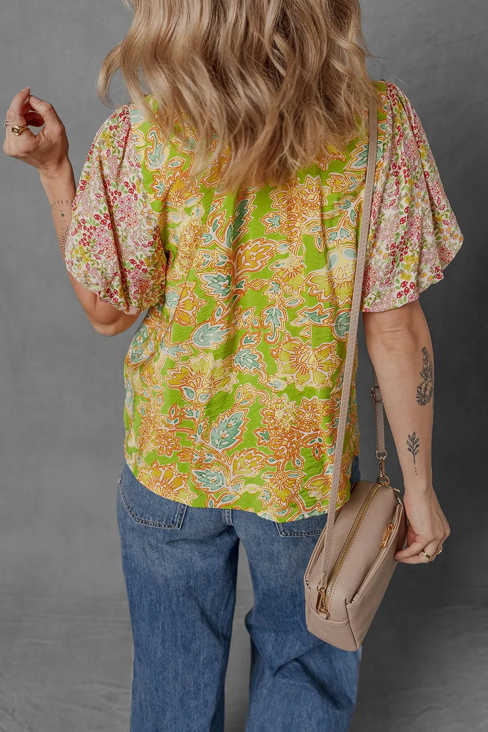 Front view of women's bubble sleeve blouse with multicolour print and patchwork.