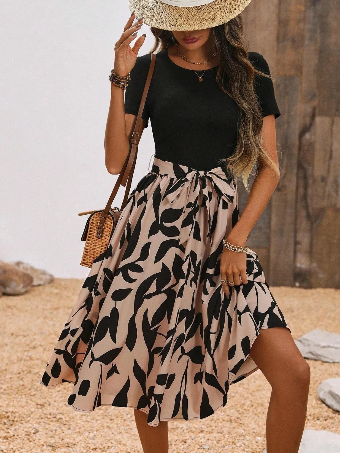 Women's midi dress featuring a round neck, short sleeves, and vibrant print.